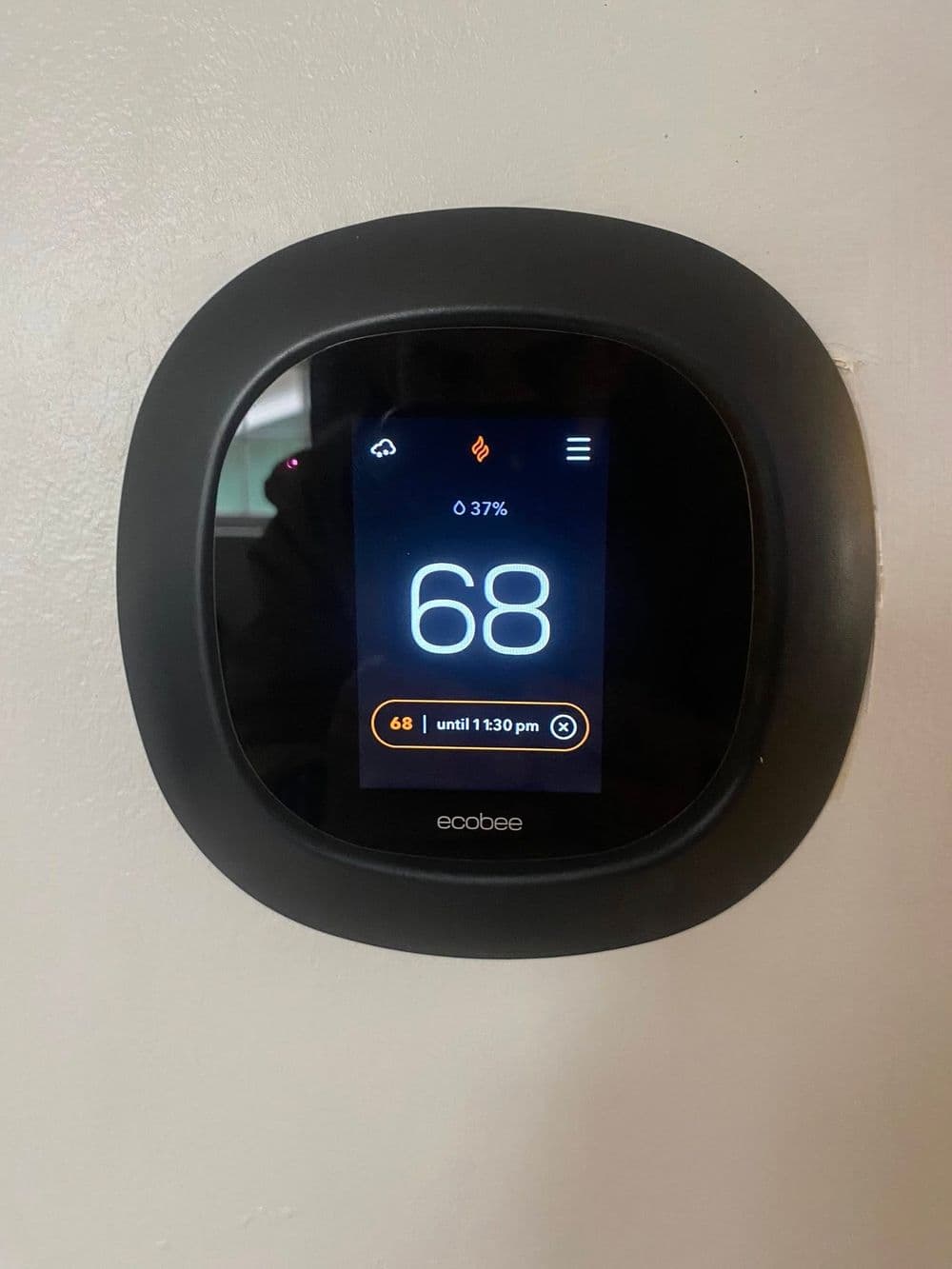 Ecobee smart thermostat displaying temperature 68°F and 37% humidity level.