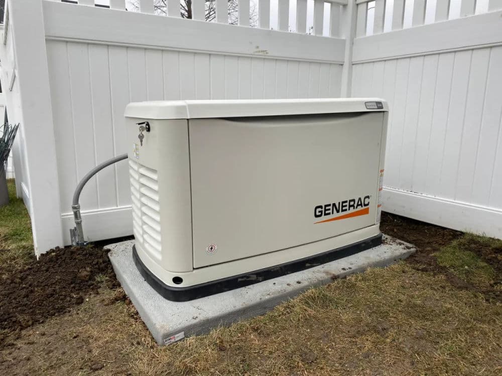 Generac home generator installed outside, providing backup power solution.